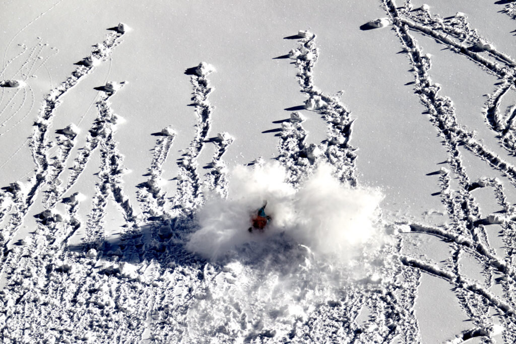 A snowboarder crashes amongst the roller balls on the free ride world tour